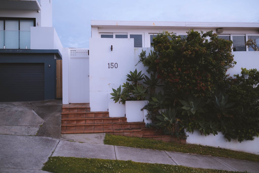Modern house facade decorated with lush vegetation in town
